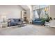 Comfortable living room with vaulted ceilings, neutral carpet, and large windows with decorative curtains at 10629 W Glasgow Ave, Littleton, CO 80127