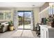 Living room featuring sliding glass doors, carpet floors, and a view of the landscaped backyard at 10629 W Glasgow Ave, Littleton, CO 80127