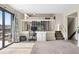 Open floor plan showing the living room with desk area and view of the kitchen at 10629 W Glasgow Ave, Littleton, CO 80127
