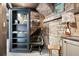 Office with unique stone archway, and rustic brick walls with built-in storage and decorative touches at 10629 W Glasgow Ave, Littleton, CO 80127