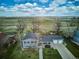 Stunning aerial view of a two-story home with landscaped yard and beautiful green space in the background at 4358 S Alton St, Greenwood Village, CO 80111
