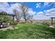 This large backyard features a dining area, mature trees and lush landscaping, and an unobstructed view at 4358 S Alton St, Greenwood Village, CO 80111