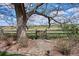 This backyard features a wooden fence and gate, a small brick pathway, and lush landscaping with a country view at 4358 S Alton St, Greenwood Village, CO 80111