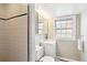 Cozy bathroom featuring a tile shower, a sink, and natural light from the window at 4358 S Alton St, Greenwood Village, CO 80111