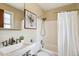 Cozy bathroom featuring a shower-tub combo, white tile, and a vanity with a sink at 4358 S Alton St, Greenwood Village, CO 80111