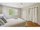 This bedroom features two closets with bright lighting, wood flooring, and a large window offering ample natural light at 4358 S Alton St, Greenwood Village, CO 80111