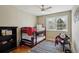 Cozy bedroom with a bunk bed, chair and pillows, complemented by natural light from the window at 4358 S Alton St, Greenwood Village, CO 80111