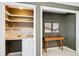 Butler's pantry featuring a sink, shelving, and a stylish desk area at 4358 S Alton St, Greenwood Village, CO 80111
