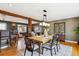Elegant dining area featuring hardwood floors, modern chandelier, and access to the living area at 4358 S Alton St, Greenwood Village, CO 80111