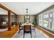 Bright dining room features a wooden table with seating for six, wood flooring, and large windows offering natural light at 4358 S Alton St, Greenwood Village, CO 80111