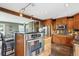 Well-equipped kitchen with stainless steel appliances, wood cabinetry and an island with bar seating at 4358 S Alton St, Greenwood Village, CO 80111