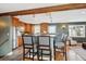 Modern kitchen with stainless steel appliances, wood cabinets and an island with bar seating at 4358 S Alton St, Greenwood Village, CO 80111