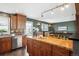 Open-concept kitchen featuring stainless steel appliances, wood countertops, and hardwood floors at 4358 S Alton St, Greenwood Village, CO 80111