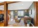Open-concept living room boasts wood beam details, hardwood floors, and seamlessly connects to the adjacent kitchen at 4358 S Alton St, Greenwood Village, CO 80111