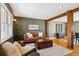 Stylish living room featuring a leather couch, a patterned rug, hardwood floors, and a decorative accent wall at 4358 S Alton St, Greenwood Village, CO 80111