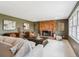 Spacious living room featuring a brick fireplace, neutral furniture, and stylish artwork at 4358 S Alton St, Greenwood Village, CO 80111