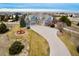 Aerial view of a beautiful home on a large lot with a circular driveway and lush landscaping at 9407 E 147Th Pl, Brighton, CO 80602