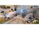 Stunning backyard featuring a patio, fire pit, rock landscaping, and white fence at 9407 E 147Th Pl, Brighton, CO 80602