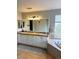 Bright bathroom features double vanity, granite countertops, and large tub next to the window at 9407 E 147Th Pl, Brighton, CO 80602