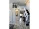 Bright foyer with hardwood floors, white banister staircase, and elegant chandelier at 9407 E 147Th Pl, Brighton, CO 80602