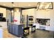 Modern kitchen with white cabinets, stainless steel appliances, and center island at 9407 E 147Th Pl, Brighton, CO 80602