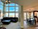 Open concept living room with floor-to-ceiling windows and adjacent dining area at 9407 E 147Th Pl, Brighton, CO 80602