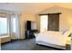 Bedroom with decorative barn door and ensuite bathroom access at 9407 E 147Th Pl, Brighton, CO 80602