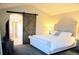 Main bedroom with barn door leading to ensuite bath and walk-in shower at 9407 E 147Th Pl, Brighton, CO 80602