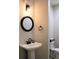 Charming powder room featuring a decorative mirror and a pedestal sink at 9407 E 147Th Pl, Brighton, CO 80602