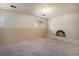 Basement with brick fireplace and window at 1947 S Ouray St, Aurora, CO 80013