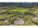 An expansive forest surrounds a charming mountain home with a three car garage at 24 Navajo Trl, Evergreen, CO 80439