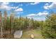 A view of the yard from the deck, with a shed and fenced in space at 24 Navajo Trl, Evergreen, CO 80439