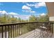 A balcony with a small outdoor furniture set and a view of the tree canopy at 24 Navajo Trl, Evergreen, CO 80439