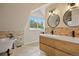 Bright bathroom features a stylish double vanity, unique tile accent, and a modern soaking tub at 24 Navajo Trl, Evergreen, CO 80439