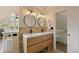 Bathroom with modern vanity, double sinks, tiled wall and walk in closet at 24 Navajo Trl, Evergreen, CO 80439