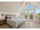 Bedroom with vaulted ceilings, balcony access, wood flooring and neutral decor at 24 Navajo Trl, Evergreen, CO 80439