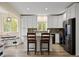 Beautiful kitchen featuring white cabinetry, stainless steel appliances, and a breakfast bar with seating at 24 Navajo Trl, Evergreen, CO 80439