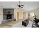 Bright living room with a stone fireplace, ceiling fan, and warm wood accents throughout at 24 Navajo Trl, Evergreen, CO 80439