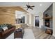 Inviting living room with a fireplace, stone accent wall, and an open-concept design leading to the kitchen at 24 Navajo Trl, Evergreen, CO 80439