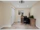 Bright home office features wood-look floors, white trim, closet and a log cabin view at 24 Navajo Trl, Evergreen, CO 80439
