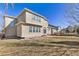 Exterior view of the home with a patio and outdoor seating area overlooking the spacious backyard at 6690 S Fenton St, Littleton, CO 80123