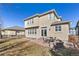 Back exterior view of the home with a patio, outdoor seating, and lush landscaping at 6690 S Fenton St, Littleton, CO 80123