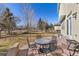 Outdoor living space with a stone patio, seating, and a well-maintained lawn at 6690 S Fenton St, Littleton, CO 80123