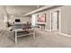 Spacious basement features a table tennis setup near a living space, combining recreation with relaxation at 6690 S Fenton St, Littleton, CO 80123