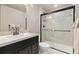 Modern bathroom featuring a sleek vanity and a glass-enclosed shower with tiled walls at 6690 S Fenton St, Littleton, CO 80123