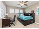 Comfortable bedroom with a desk area and ample storage, bathed in natural light at 6690 S Fenton St, Littleton, CO 80123