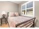 Cozy bedroom with a comfortable bed, side table, and large window providing natural light at 6690 S Fenton St, Littleton, CO 80123