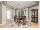 Formal dining room with trey ceiling, hardwood floors, and seating for six around a beautiful wooden table at 6690 S Fenton St, Littleton, CO 80123