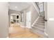 Spacious entryway featuring hardwood floors, staircase, and an open view to the living room with fireplace at 6690 S Fenton St, Littleton, CO 80123