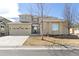 Charming two-story home with an attached two-car garage and mature trees at 6690 S Fenton St, Littleton, CO 80123